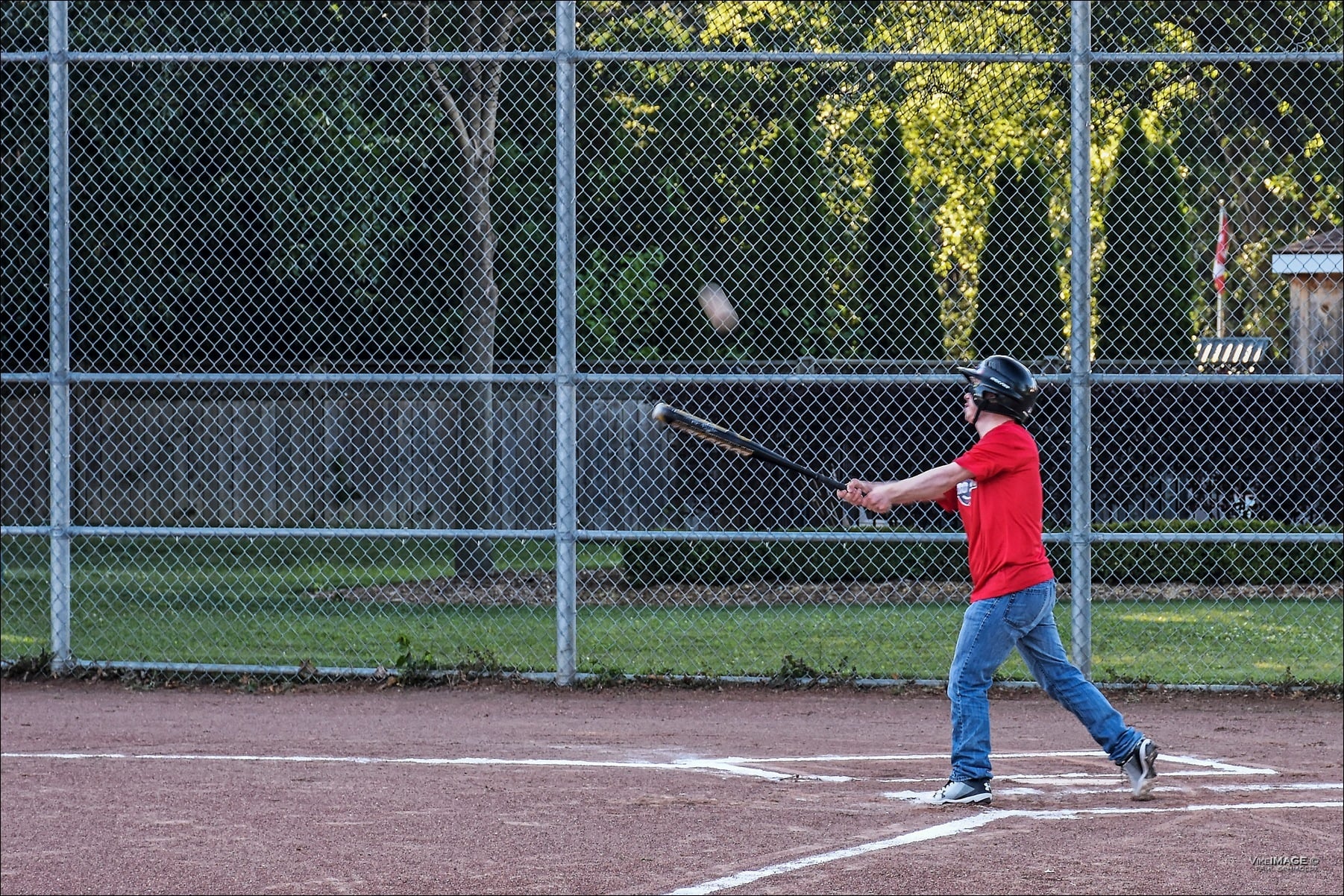 A person hitting a baseball with a bat